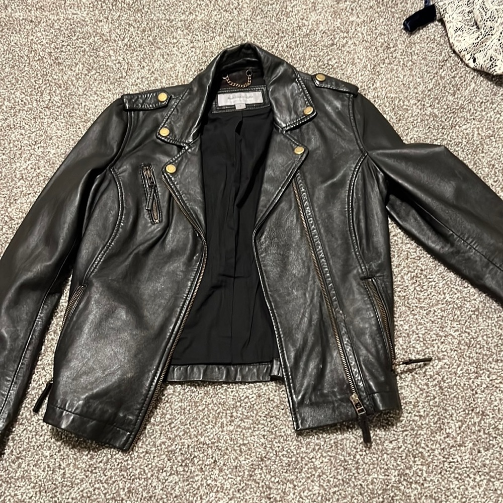 Gently worn leather jacket with metal detailing